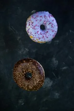 Selective focus, levitating sweet doughnuts with chocolate and blueberry Stock Photos