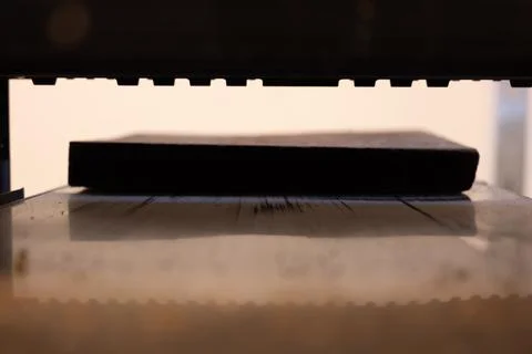 Selective focus looking into a wood planer bed raised above the board Stock Photos