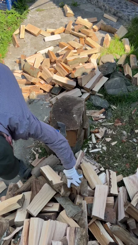 Selective focus lumberjack cutting wood outdoors 動画素材 335589309