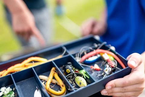 Selective focus on lure inside an open fishing tackle box. Foto stock