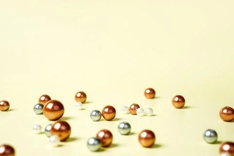 Selective focus on luxury elegant colored pearl on yellow beige background copy Stock Photos