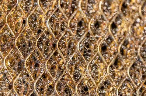 Selective focus macro of a dirty kitchen range hood filter clogged with grease. Foto stock