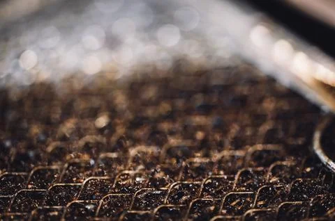 Selective focus macro of a dirty kitchen range hood filter clogged with grease. Foto stock