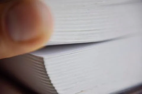 Selective focus, macro look at the pages of the thick book Stock Photos