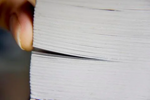 Selective focus, macro look at the pages of the thick book Stock Photos