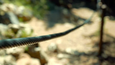 Selective focus of a man descends from a mountain Stock Footage 202337345