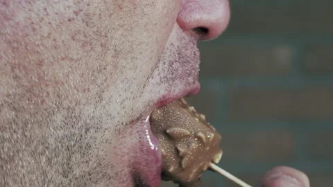 Selective focus. Man eating ice cream. Caucasian man with chocolate delicacy. Stockbeeldmateriaal 137038269