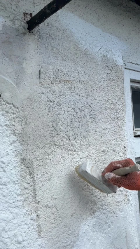 Selective focus manual whitewashing of house facade Stock Footage 334329777