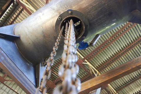 Selective focus on manual winch chains for lifting equipment Stock Photos