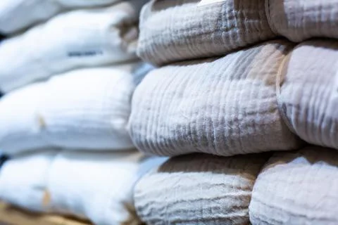Selective focus to many bed sheet and bedding folded in the shop. Stock Photos