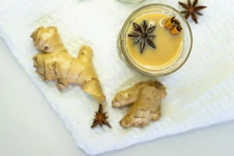 Selective focus, masala tea on white background with cinnamon and ginger spic Stock Photos