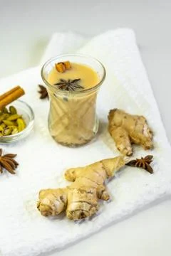 Selective focus, masala tea on white background with cinnamon and ginger spic Stock Photos