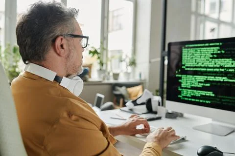 Selective focus on mature IT engineer decoding information Stock Photos