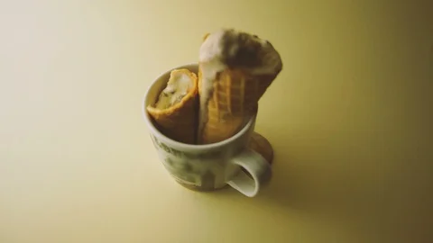 Selective focus of melting ice cream cones in a mug. zoom in footage Stock Footage 103276754