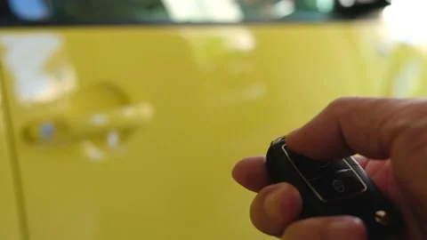 Selective focus at men hand press the button of car remote to unlock with bli Video stock 146363965