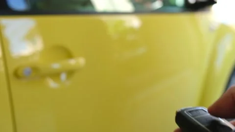 Selective focus at men hand press the button of car remote to unlock with bli Video stock 146363990