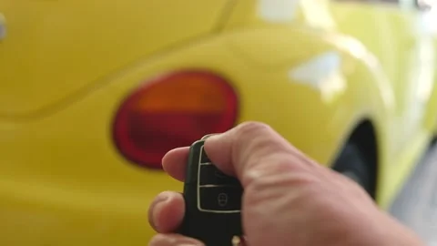 Selective focus at men hand press the button of car remote to unlock with bli Video stock 146363994