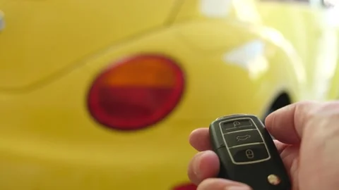 Selective focus at men hand press the button of car remote to unlock with bli Video stock 146364002