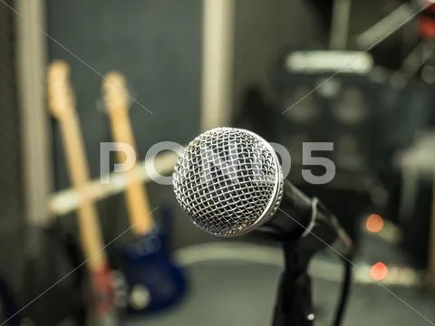 Selective Focus On Microphone With Blurry Music Studio Background