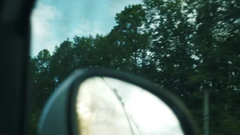 Selective focus of mirror of automobile car while driving along road through Stock Footage 284912130