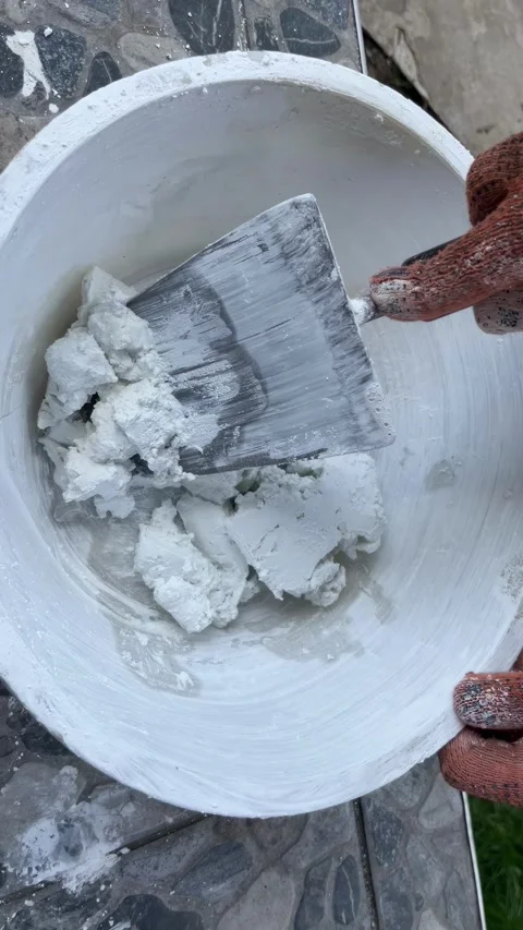 Selective focus mixing putty in basin Stock Footage 334329436