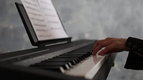 Selective focus, modern piano, close up with woman hand playing Stock Footage 241492943