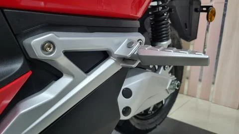 Selective focus of motorcycle foot peg made of iron or steel. Stock Photos
