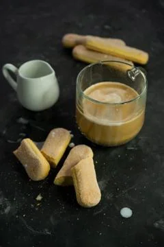 Selective focus, mug of hot coffee with cream and cookies Stock Photos