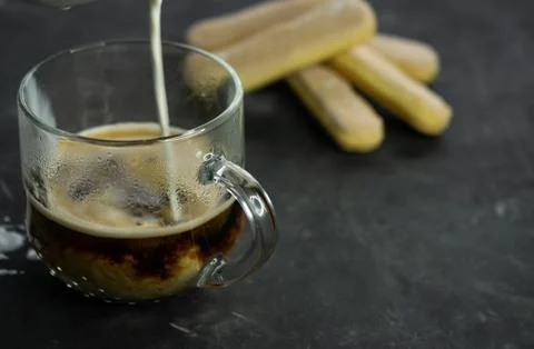 Selective focus, mug of hot coffee with cream and cookies Stock Photos