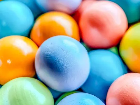 Selective focus from multicolored bright small wooden balls of blue, yellow, red Stock Photos
