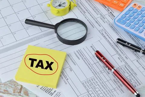 Selective focus of office tools and memo note with word TAX Stock Photos