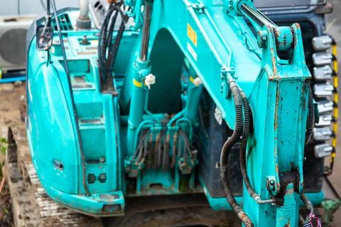 Selective focus to old blue bulldozer is stationary waiting to be repaired. Stock Photos