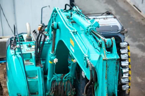 Selective focus to old blue bulldozer is stationary waiting to be repaired. Stock Photos