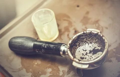 In selective focus of old hot coffee grain with wet and dirty portafilter.Clo Stock Photos