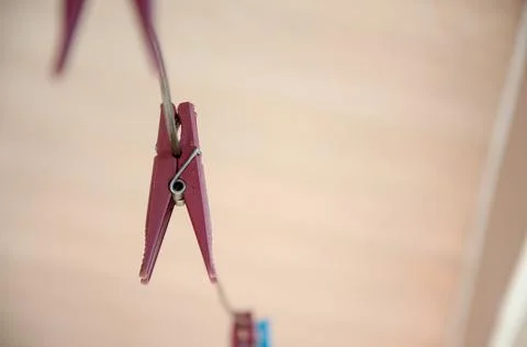 Selective focus old plastic clothespin hang on the wire. Stock Photos