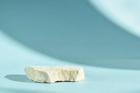 Selective focus. One stone podium on a light blue background with beautiful s Stock Photos