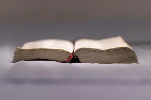 Selective focus of an open Bible placed on a bed Stock Photos