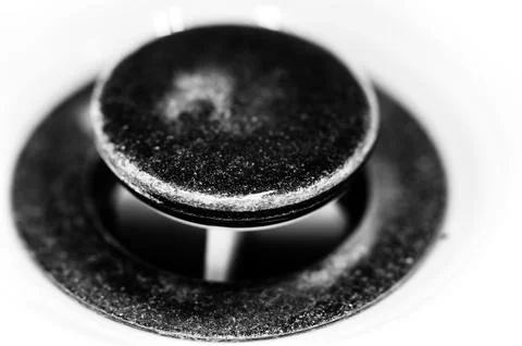 Selective focus on an open bronze sink drain. Stock Photos