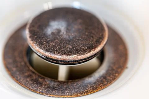 Selective focus on an open bronze sink drain. Stock Photos