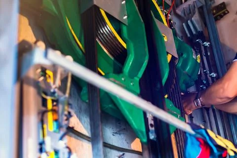 Selective focus to part of elevator lift equipment with blurry hand of lift m Stock Photos