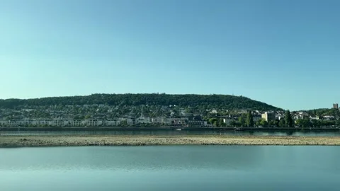 Selective focus peaceful Rhine River surrounded by lush green hills Stock Footage 345593276