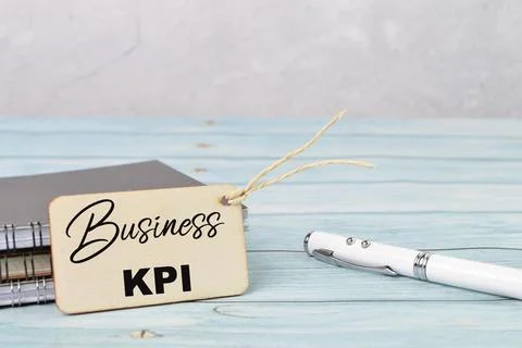 Selective focus of pen, notebook and label tag written with BUSINESS KPI Stock Photos