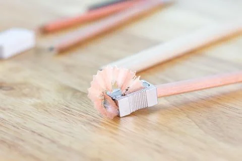Selective focus pencil with pencil sharpener for writing on wood table Photos