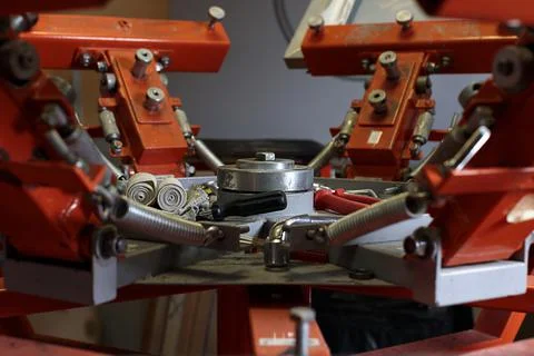 Selective focus photo of working tools on print screening apparatus. Stock Photos