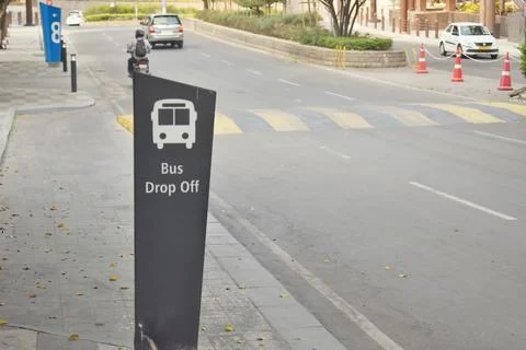 A Selective focus Picture of a Bus Drop Off area Sign in a Software Park in Stock Photos