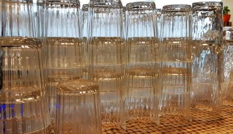 Selective focus. pile of empty transparent glasses on shelf. Close up of Stock Photos