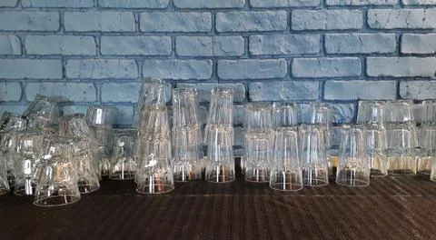Selective focus. pile of empty transparent glasses on shelf. Close up of Stock Photos
