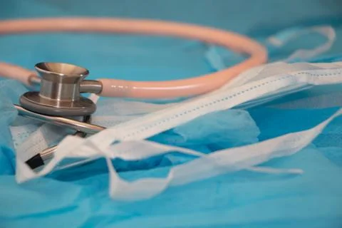 Selective focus on a pink stethoscope standing on medical elements-9063 Stock Photos