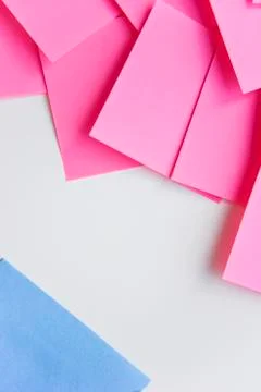 Selective focus, pink stickers in one corner and blue one in the opposite cor Stock Photos