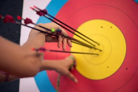 Selective focus on the pink target with colorful arrows in it Stock Photos